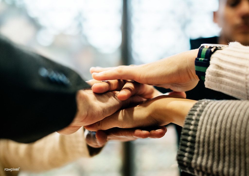 People putting their hands together