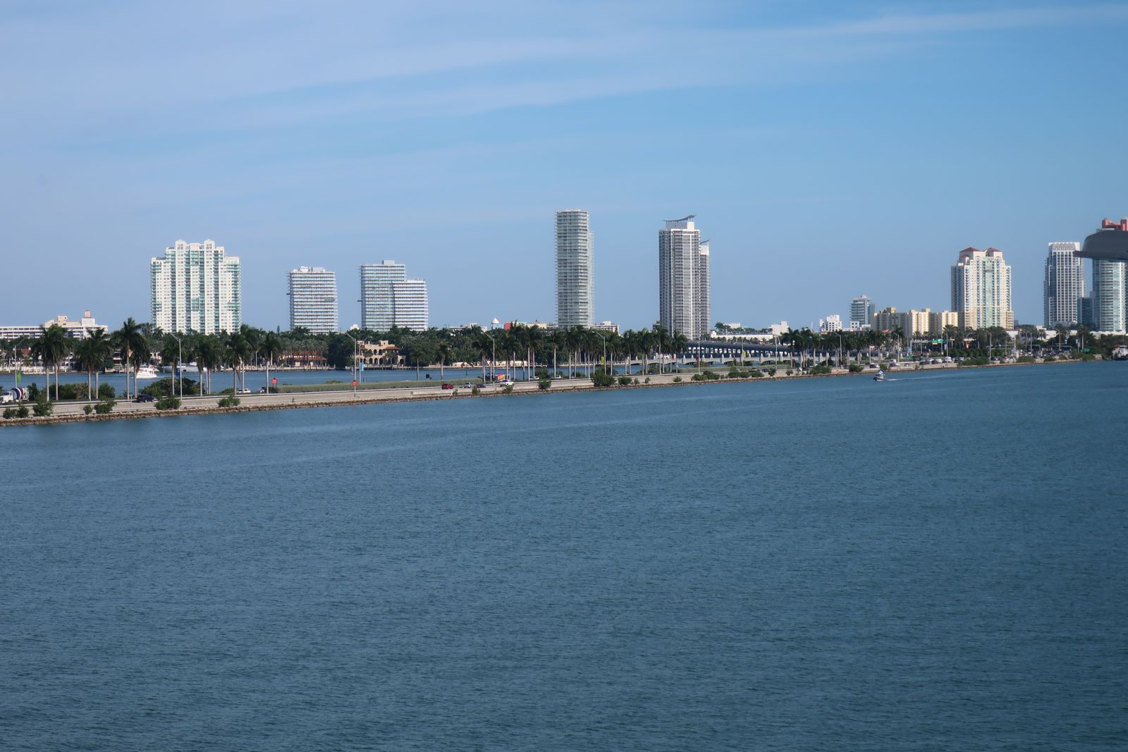 Miami Beach towers and the causeway seen across calm water in daylight